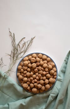 Edible caramel clay stones with dried leaves flat lay photo