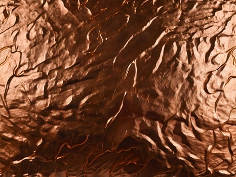 A magnified capture of brushed copper with a warm, radiant glow. photo