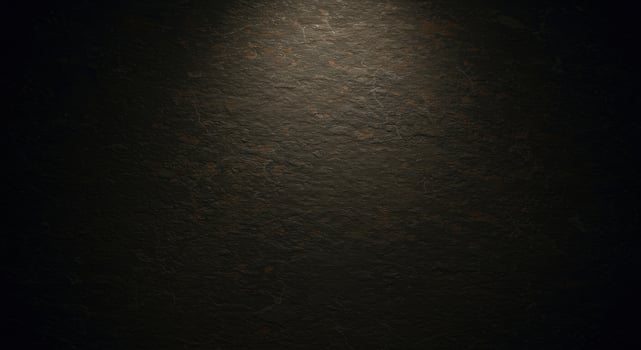 A dark background with a light shining on it photo