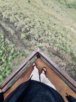 Standing on Rusty Platform Overlooking Grassy Landscape photo