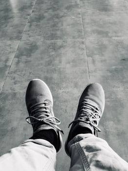 Monochrome View of Sneakers on Tiled Floor photo