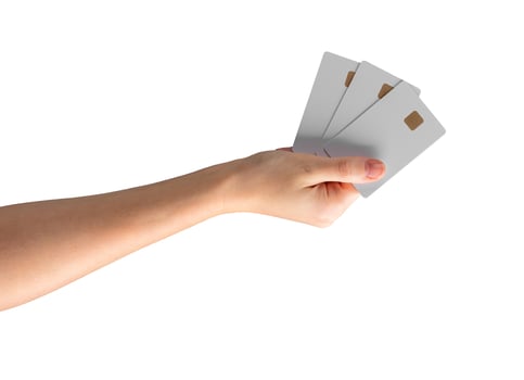 Young female hand holding a blank credit card, ideal for showcasing promotions, shopping, and photo