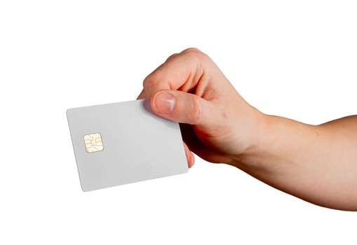 Female hand holding a blank credit card, tilted to showcase electronic payment, debit services, and photo