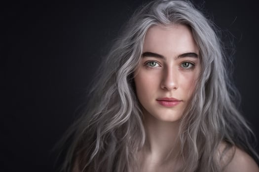 A woman with long gray hair and green eyes photo