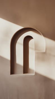 A wall with a window and a light coming through it photo
