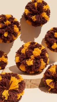 Brown and yellow pom poms with copy space photo