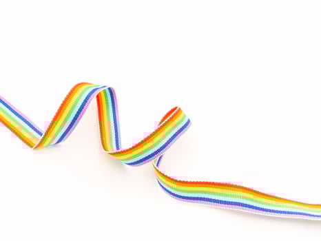 Top view of a rainbow cloth ribbon on a white background. photo