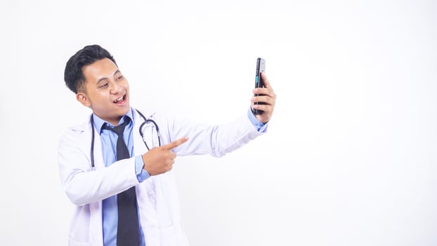 Handsome Asian Male Doctor Making Phone Call on White Doctor photo