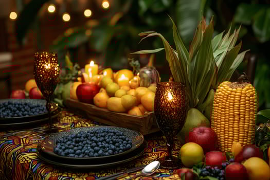 Kwanzaa celebration with a table full of traditional food, fruits and illuminated by candles photo