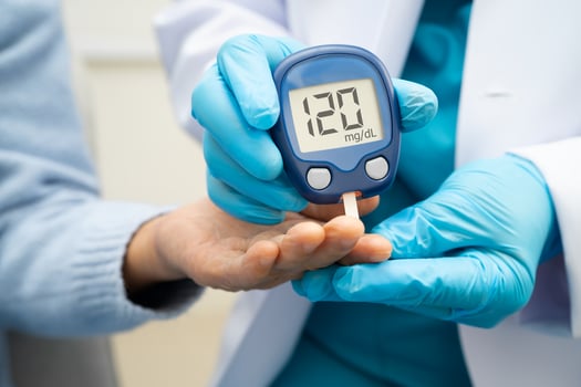 doctor using digital glucose meter for check sample blood diabetes. photo