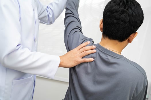 Physical therapy, Asian therapist doctor treat perform pain young man in hospital. photo