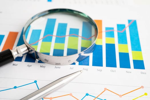 Magnifying glass on charts graphs paper. Financial development, Banking Account Statistic photo
