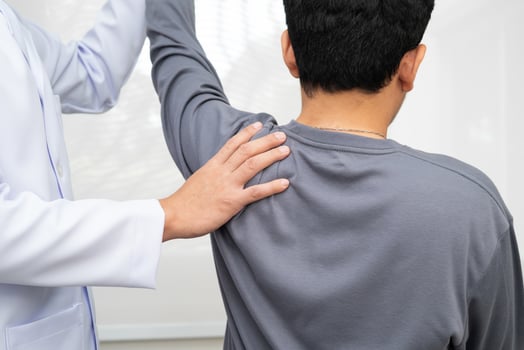 Physical therapy Asian therapist doctor treat perform pain young man photo