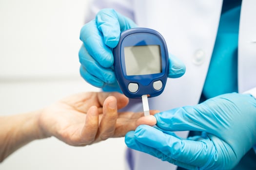 doctor using digital glucose meter photo