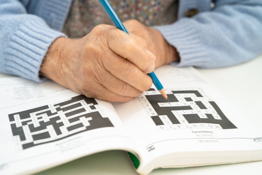 elderly woman playing puzzle game. photo