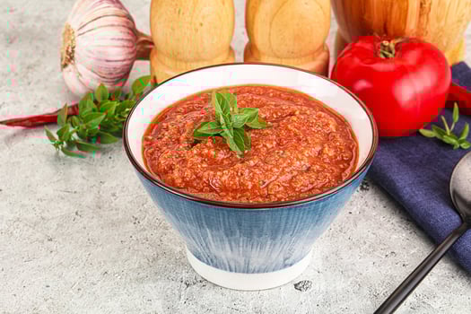 A bowl of tomato sauce with spices and herbs photo