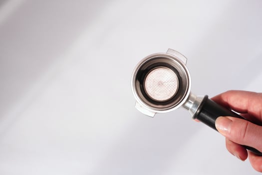 Coffee portafilter being examined photo