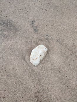Large white sea rock on the beach photo