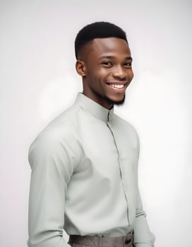 Happy Nigerian male in fashionable outfit, smiling directly at the camera with a neutral background photo