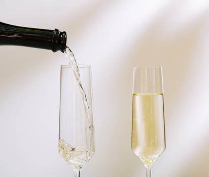 Pouring sparkling beverage into a flute glass for a celebration photo