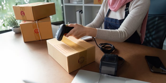 Using a barcode scanner on a package for shipping preparation photo
