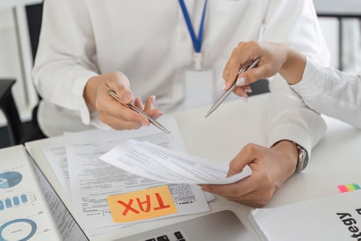 Team discussing tax forms and financial strategies in an office photo