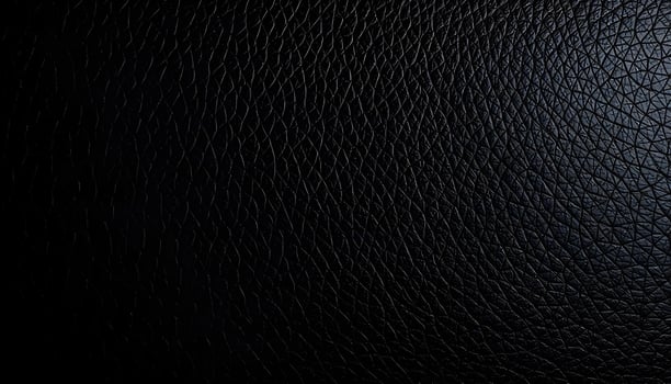 Dark black leather texture, smooth finish, visible pores, stitching details, single light source photo