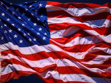 An american flag is blowing in the wind photo