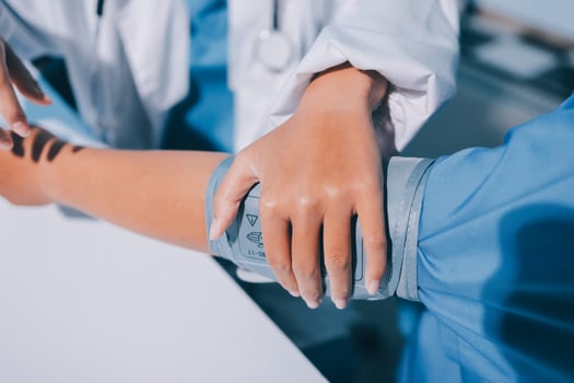 A doctor is holding the arm of a patient photo