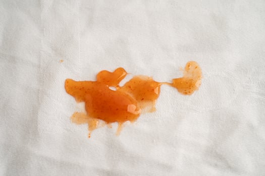 Dirty tomato sauce stain or ketchup on cloth to wash photo