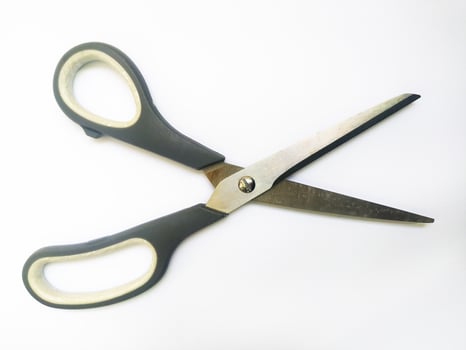 Closeup of simple, everyday scissors on a white background. A clean, minimalist image suggesting concepts of cutting, precision, and new beginnings. photo