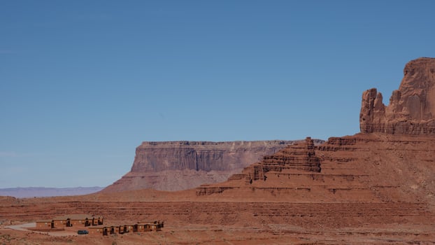 Remote cabins nestled in the vast desert landscape of Monument Valley. Concept of isolation, travel, adventure, and Native American heritage. photo