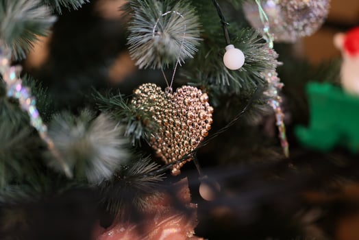 An Elegant Heart Ornament Beautifully Decorates a Christmas Tree for the Holiday Season photo
