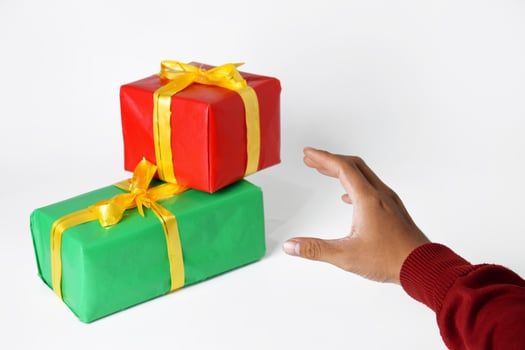 A person's hand in a sweater points with a red and green square finger photo