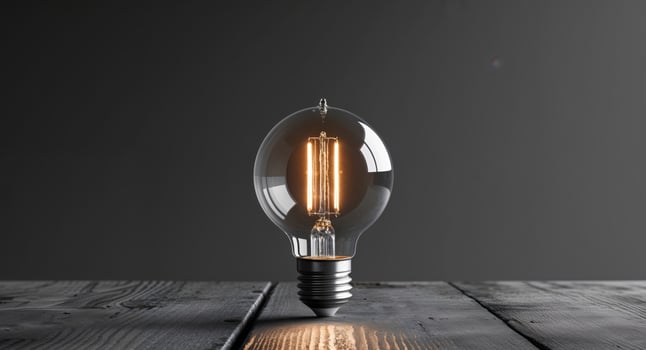 A light bulb on a wooden table photo