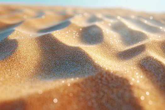 Close-up of shimmering golden sand dunes under bright sunlight, creating a warm and inviting atmosphere. photo