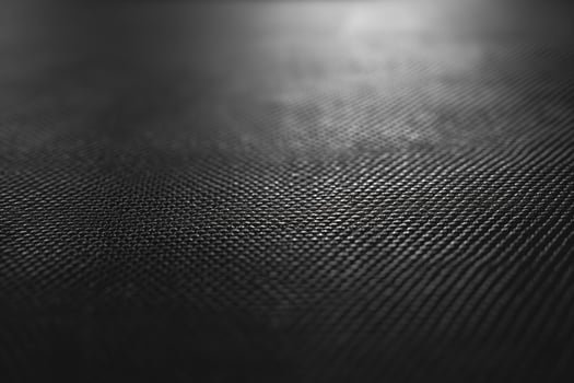 Close-up view of a dark textured surface, highlighting intricate patterns and depth. photo