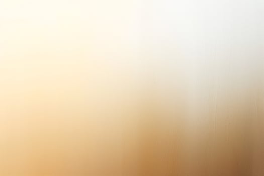 A soft, blended gradient of warm beige and light cream colors creates a serene backdrop. photo