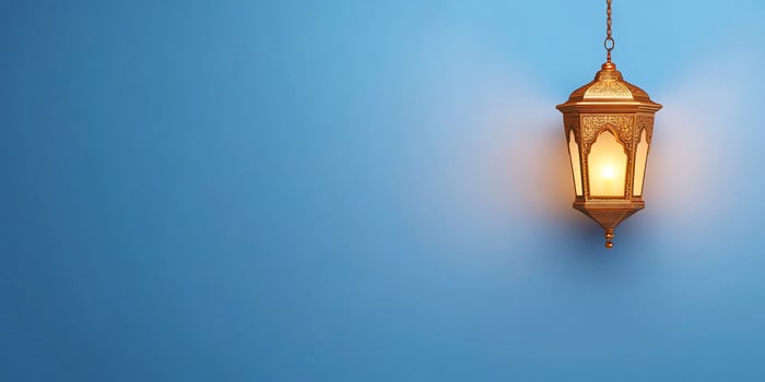A lamp hanging from a blue wall photo