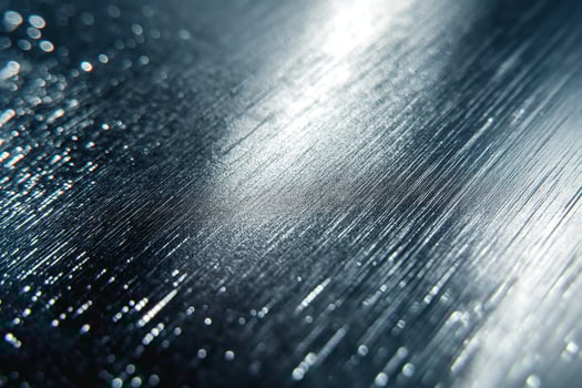 Close-up of a textured metal surface reflecting light beautifully. photo