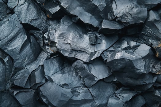 A close-up of textured dark slate rock formations showcasing unique patterns and colors. photo