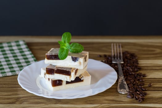 Milk dessert. coffee jelly pieces inside white milk jelly photo