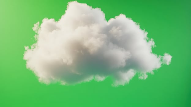 White fluffy cloud floating against a bright green background in an abstract and surreal setting during the daytime photo
