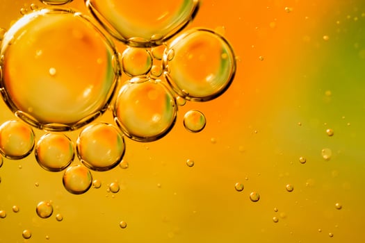 oil drops on water on an orange background photo