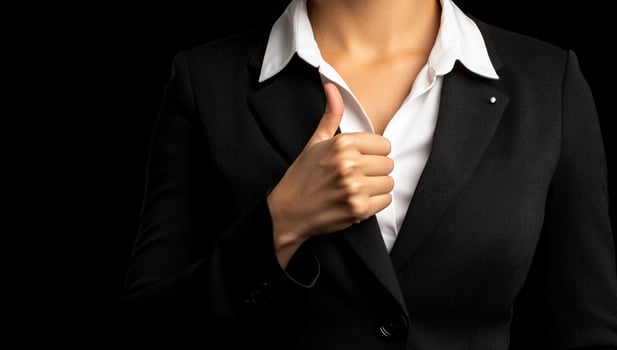 A business professional giving a thumbs-up gesture. photo