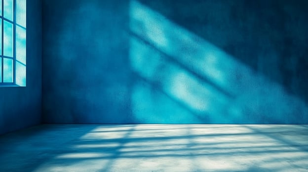 Sunlight streams through the window, casting shadows across the blue-painted walls and floor, illuminating an empty interior space. photo