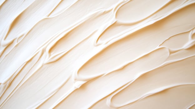 Creamy texture of smooth frosting spread evenly on a surface in a well-lit kitchen, capturing the art of baking during the afternoon photo