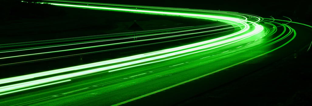 green car lights at night. photo