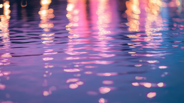 Vibrant reflections sway and shimmer on the calm surface of the water under the night sky, all alongside a bustling waterfront photo