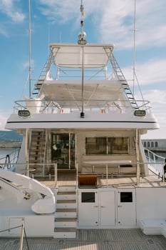 Steps aboard a white double-deck yacht photo